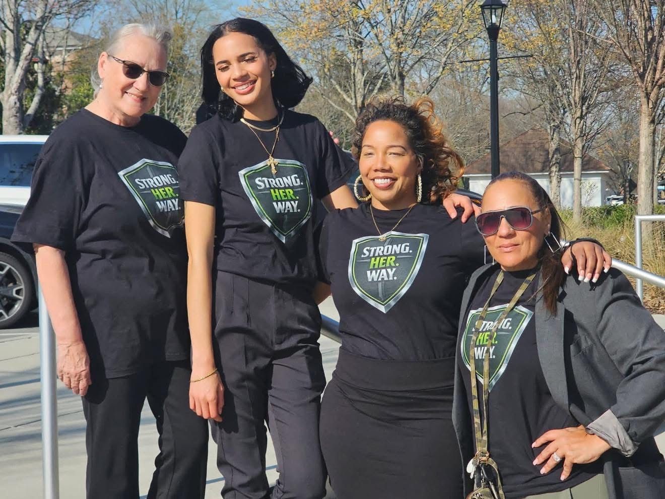 Tanya Robinson (right) and the founding team in shield tees at the March 22 launch