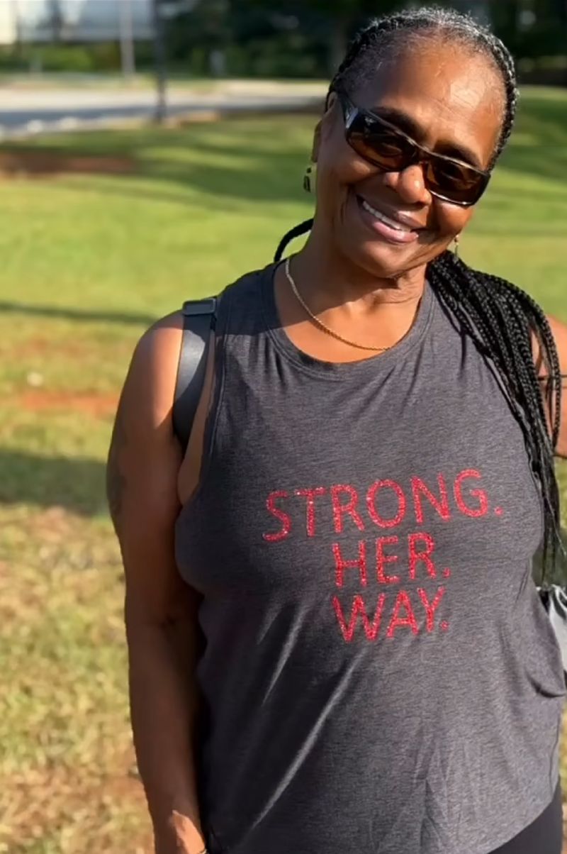 Member in a Strong. Her. Way. tank after a park workout